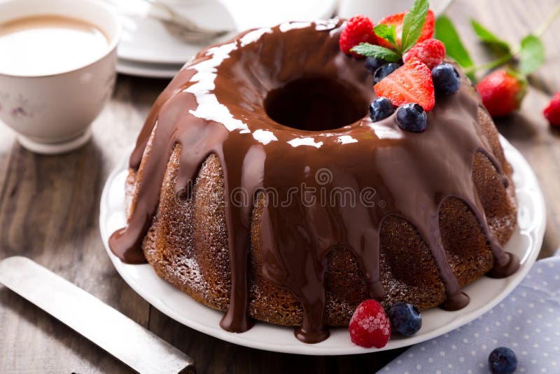 Chocolate bundt cake with melted chocolate and frozen berries. Chocolate bundt cake with melted chocolate and frozen berries