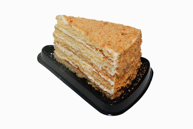 Gâteau de miel avec de la crème sur le support en plastique noir de disposition photo libre de droits Gâteau de miel avec de la crème sur le support en plastique noir de disposition photo libre de droits