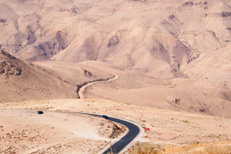 Jordan 05/10/2013: Jordanian and desert landscape with the winding road to Mount Nebo, an elevated ridge mentioned in the Hebrew Bible as the place where Moses was granted a view of the Promised Land. Jordan 05/10/2013: Jordanian and desert landscape with the winding road to Mount Nebo, an elevated ridge mentioned in the Hebrew Bible as the place where Moses was granted a view of the Promised Land