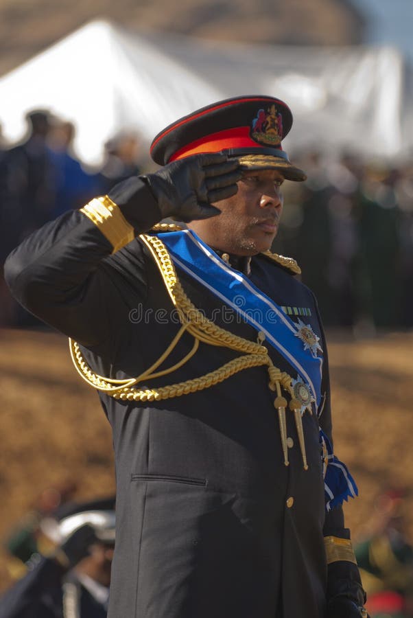 H.R.H King Letsie of Lesotho saluting in military uniform during his birthday parade with soldiers in background. H.R.H King Letsie of Lesotho saluting in military uniform during his birthday parade with soldiers in background.