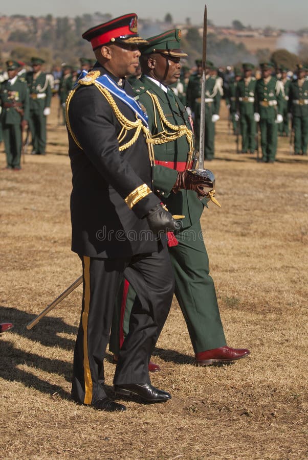 Side view of H.R.H King Letsie walking in military uniform inspecting troops on parade for his birthday; Lesotho. Side view of H.R.H King Letsie walking in military uniform inspecting troops on parade for his birthday; Lesotho.