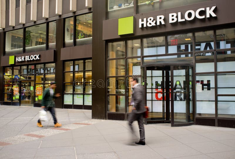 People walking in front of the H&R Block office. People walking in front of the H&R Block office