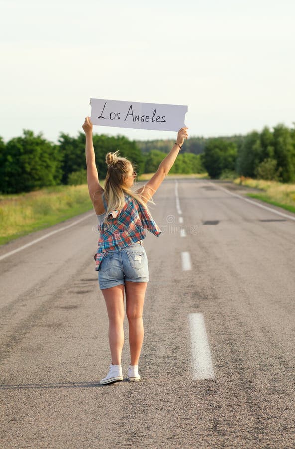Beautiful Girl Hitchhiking on the Road Traveling Arkivfoto - Bild av ...