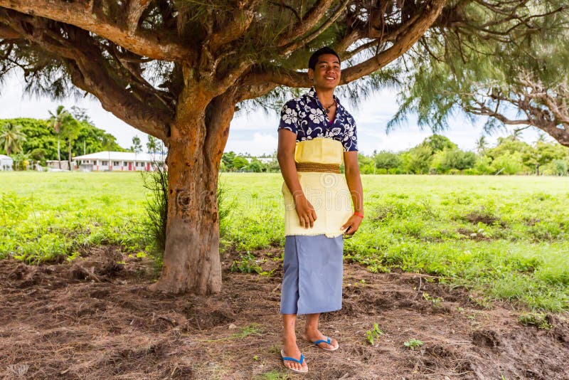 Smart well dressed Polynesian teenager boy in traditional Tongan dress just out of church as Catholic Mass ends. Tonga, Polynesia.