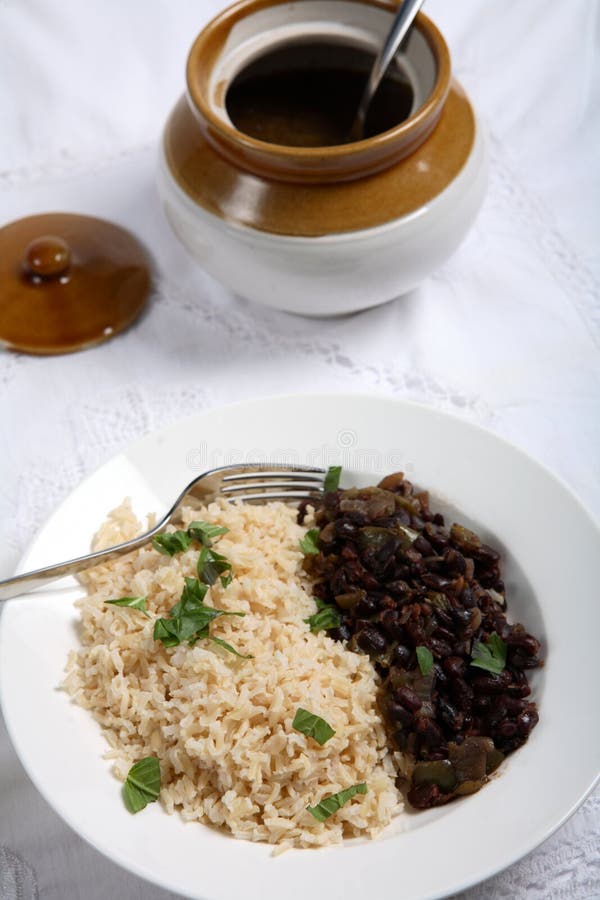 Cuban black-beans and rice, a very traditional dish known as Moors and Christians Moros y Cristianos with a serving pot. Cuban black-beans and rice, a very traditional dish known as Moors and Christians Moros y Cristianos with a serving pot.