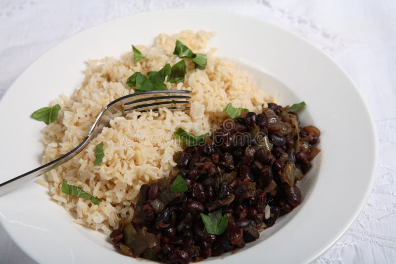 Cuban black-beans and rice, a very traditional dish known as Moors and Christians Moros y Cristianos with a fork. Cuban black-beans and rice, a very traditional dish known as Moors and Christians Moros y Cristianos with a fork