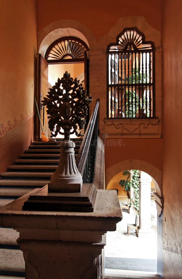 Detail of the stairs on a typical mexican farm house with a wood tree and the wood frame on a door and a window. City of Guanajuato, mexican colonial heartland of Mexico. Detail of the stairs on a typical mexican farm house with a wood tree and the wood frame on a door and a window. City of Guanajuato, mexican colonial heartland of Mexico.