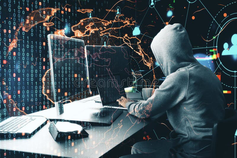 Hacker at desktop using laptop with digital ear stock image
