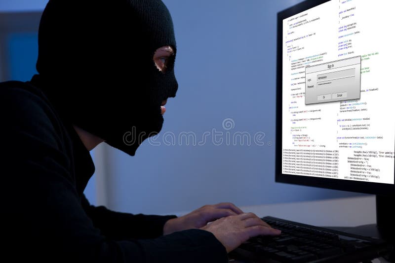 Hacker downloading information off a computer stock photography