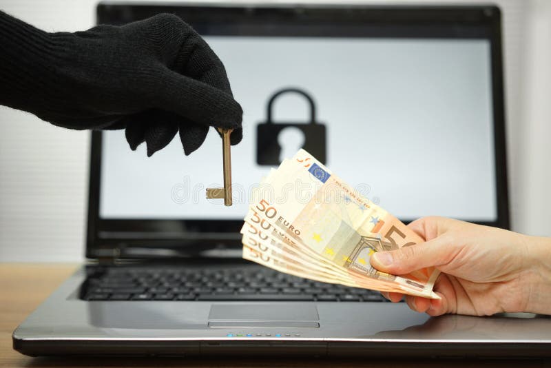 Hacker gives key to victim to restore the personal data on laptop computer stock photography