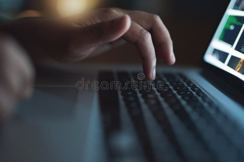 Hacker, hand and typing on laptop at night as thief for malware, hacking database software or hardware virus of firewall stock photography