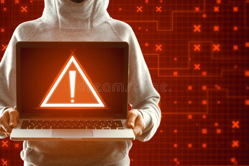 Hacker holding laptop with creative red security alert on background. Fraud and danger concept royalty free stock image