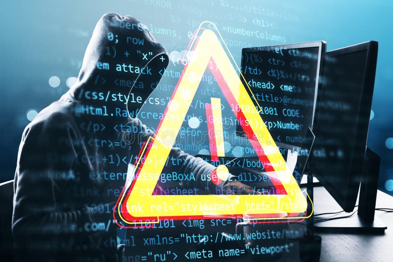 Hacker in hoodie working on a computer with digital warning sign overlay and code in background royalty free stock photography