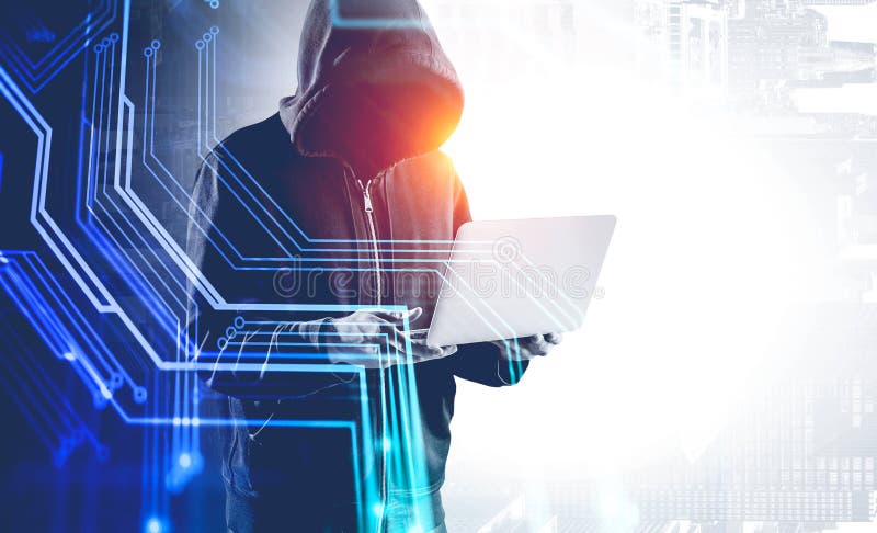 Hacker with laptop in city and circuit interface stock photo