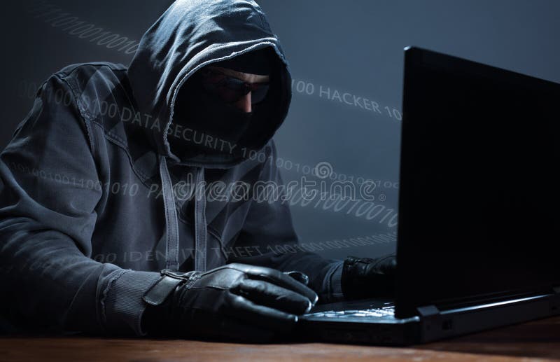 Hacker stealing data from a laptop stock photos