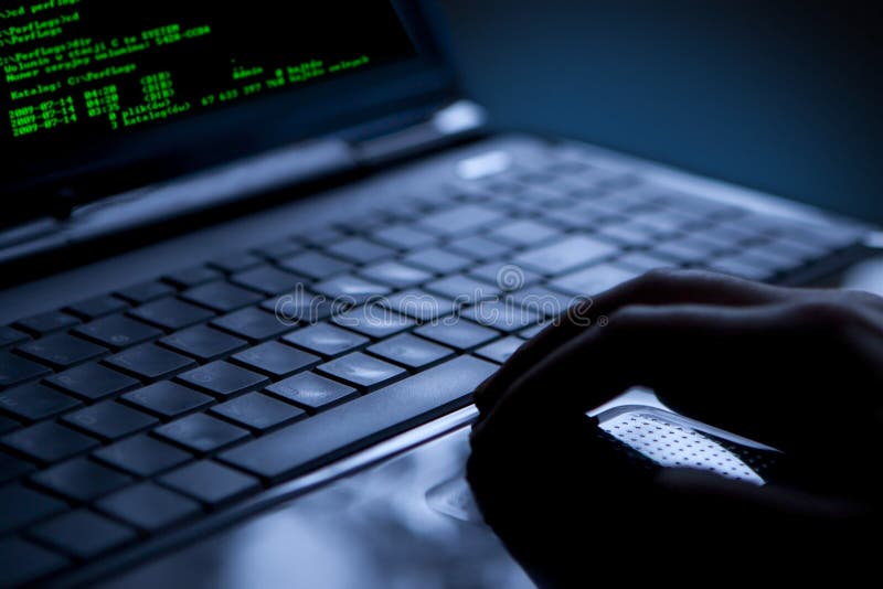 Hacker stealing data from a laptop royalty free stock photo