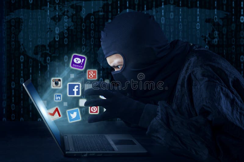 JAKARTA, SEPTEMBER 21, 2015: Male thief wearing mask and stealing information of social media account like facebook, twitter, instagram, email, and yahoo with laptop. JAKARTA, SEPTEMBER 21, 2015: Male thief wearing mask and stealing information of social media account like facebook, twitter, instagram, email, and yahoo with laptop