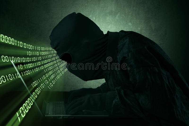 Hacker typing on a laptop stock images
