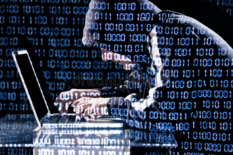 Hacker typing on a laptop royalty free stock image