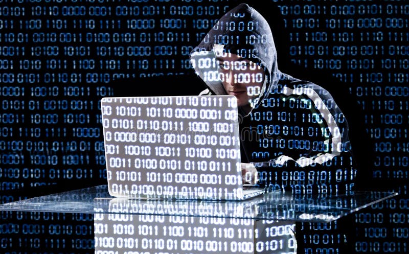 Hacker typing on a laptop stock images