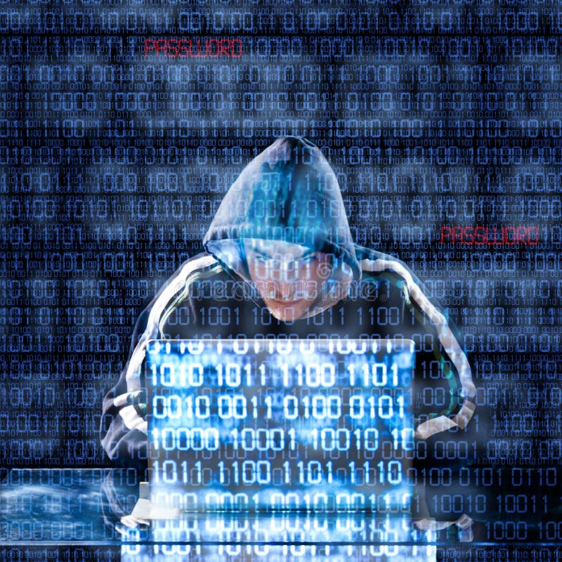 Hacker typing on a laptop stock photo