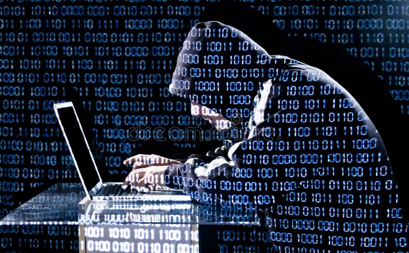 Hacker typing on a laptop stock images