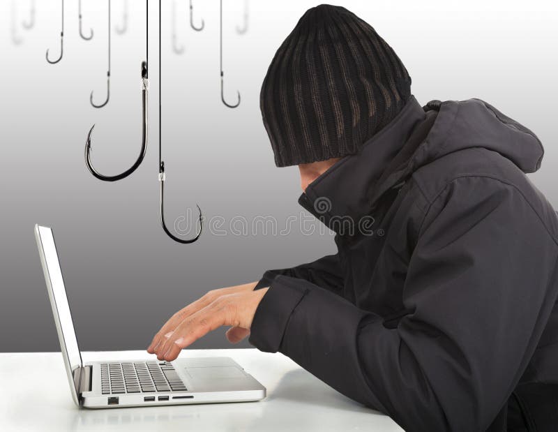 Hacker working with a laptop computer and hooks stock images