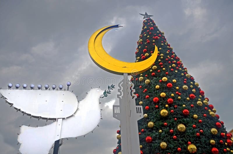 HAIFA, ISRAEL - DECEMBER 30, 2017: Holiday decorations street for holidays, Christmas tree and Hanukkah menorah in the form of a royalty free stock image HAIFA, ISRAEL - DECEMBER 30, 2017: Holiday decorations street for holidays, Christmas tree and Hanukkah menorah in the form of a royalty free stock image