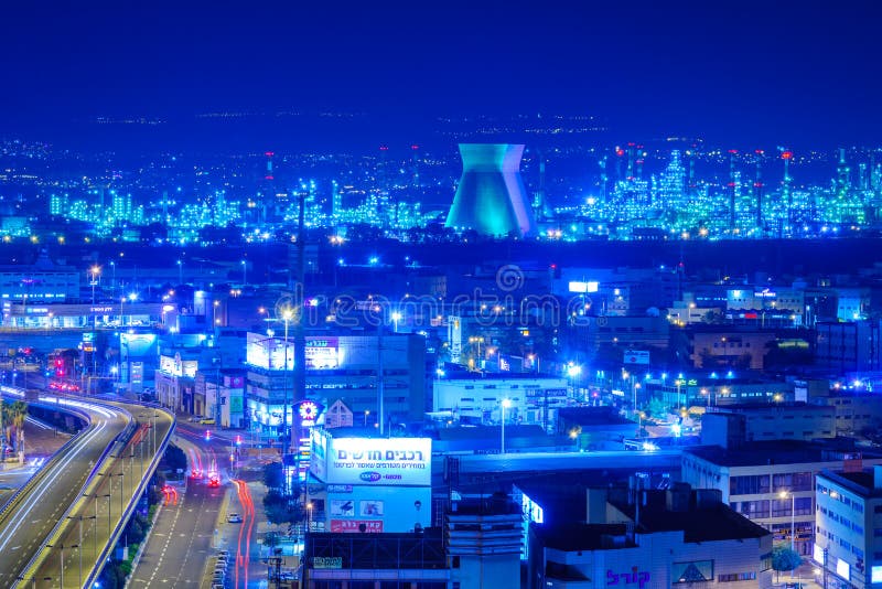 HAIFA, ISRAEL - NOVEMBER 05, 2015: Night view of the bay commercial area, with the refineries and local businesses, in Haifa, Israel. HAIFA, ISRAEL - NOVEMBER 05, 2015: Night view of the bay commercial area, with the refineries and local businesses, in Haifa, Israel