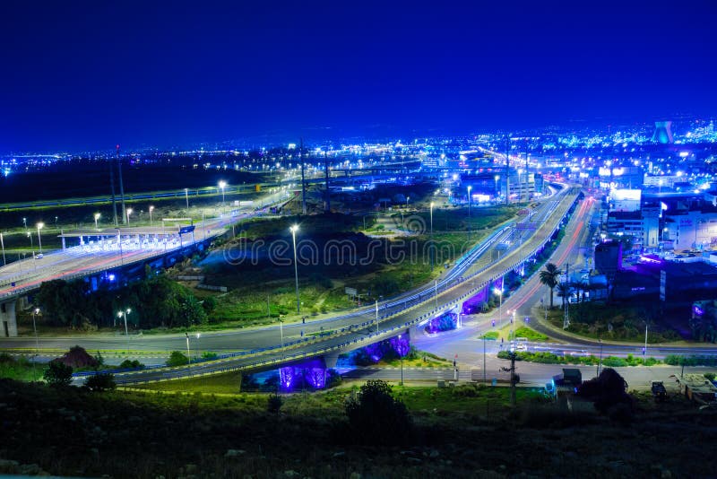 HAIFA, ISRAEL - NOVEMBER 05, 2015: Night view of the bay commercial area, with the refineries and local businesses, in Haifa, Israel. HAIFA, ISRAEL - NOVEMBER 05, 2015: Night view of the bay commercial area, with the refineries and local businesses, in Haifa, Israel