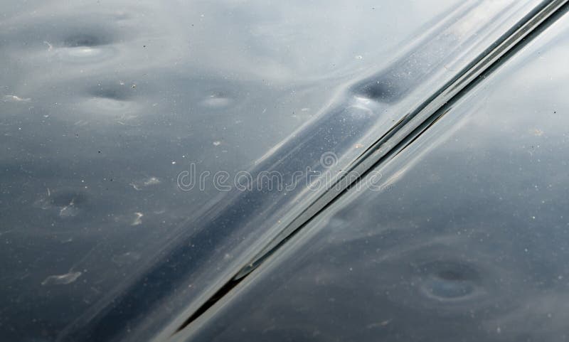 Hail Damage On Black Car Hood stock image Hail Damage On Black Car Hood stock image