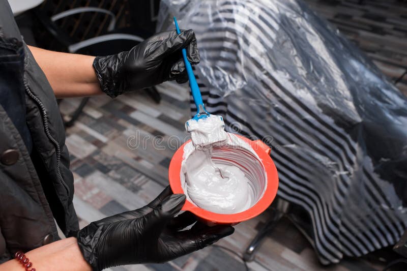 Hair Coloring Process Mixing Ingredients in a Brush Paint Container Dye