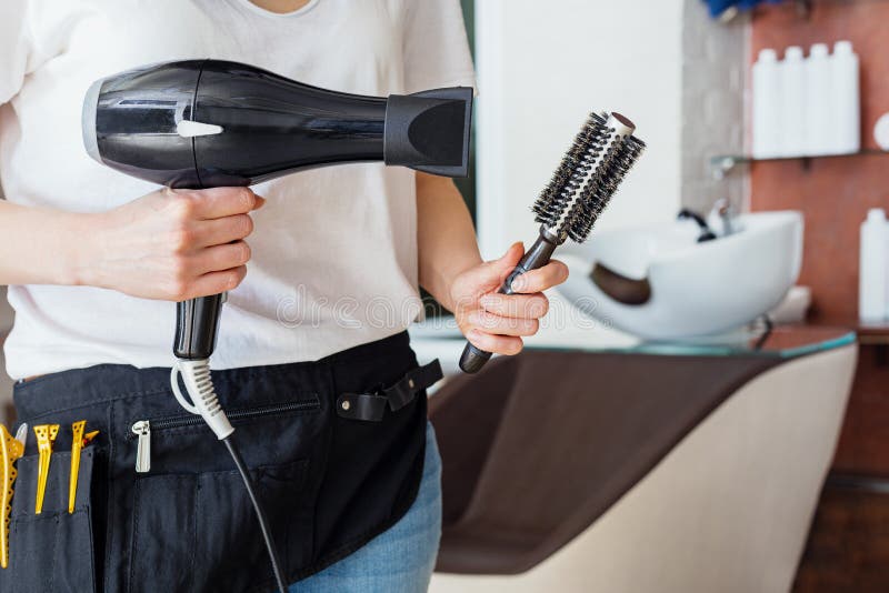 Hair Dryer, Comb Brush in Hairdressers Hands Against Beauty Salon, Barber Shop Interior, Wash Sink Chaire. Professional Tools for Stock Photo - Image of design, haircut: 184008866 Hair Dryer, Comb Brush in Hairdressers Hands Against Beauty Salon, Barber Shop Interior, Wash Sink Chaire. Professional Tools for Stock Photo - Image of design, haircut: 184008866