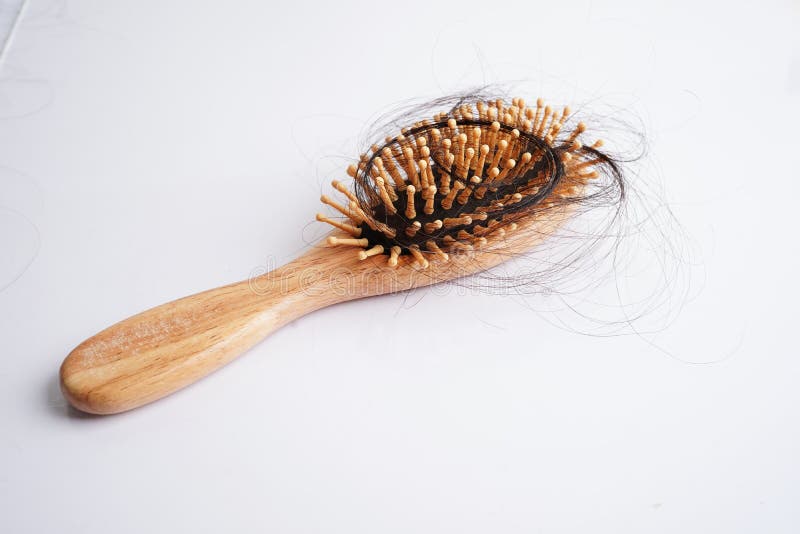 Hair Loss Fall with Comb Brush Isolated on White Background Stock Photo