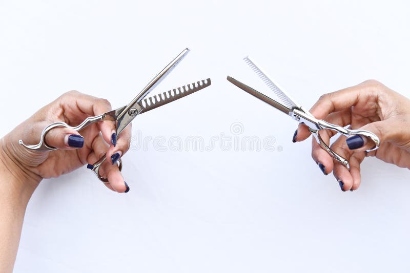 Hands Of A Hair Stylist Trimming Hair With A Comb And Scissors Stock