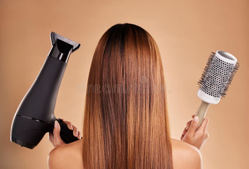 Hair, styling and brush with hairdryer and woman in studio for beauty, grooming and salon blowout. Cosmetics, glamour