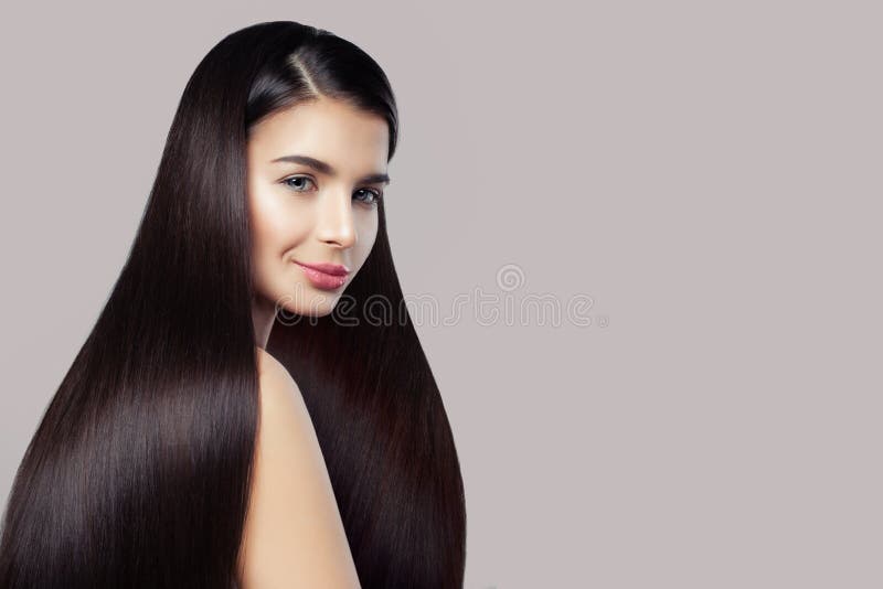 Haircare concept. Beauty brunette woman with long straight healthy hair on pink stock image Haircare concept. Beauty brunette woman with long straight healthy hair on pink stock image
