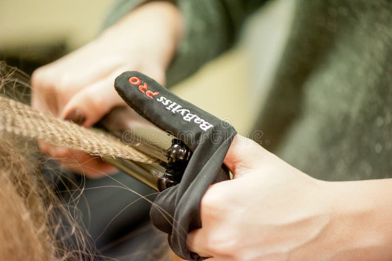 VILNIUS, LITHUANIA - FEBRUARY 11, 2012: Haircut Scissors and Hairstile. Professional hair care and creating hairstyles. royalty free stock photography VILNIUS, LITHUANIA - FEBRUARY 11, 2012: Haircut Scissors and Hairstile. Professional hair care and creating hairstyles. royalty free stock photography