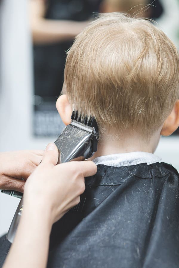 Hairdresser in Barbershop Machine Clipper Trimmer Cuts Hair Child Boy.  Lifestyle Close-up Stock Image - Image of people, hairdressing: 210829981