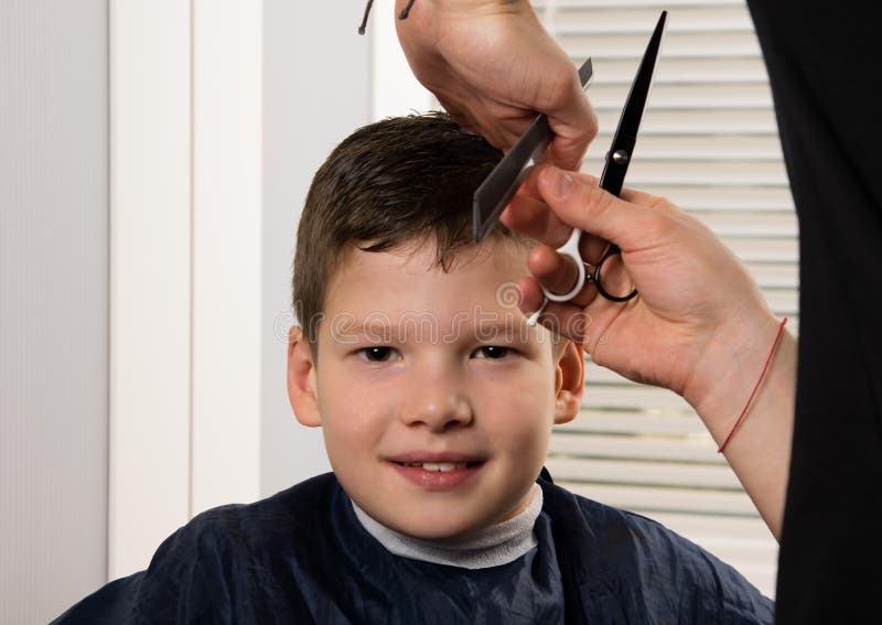 Hairdresser Boy Does a Haircut with Scissors and Comb Stock Photo - Image  of male, salon: 120331212