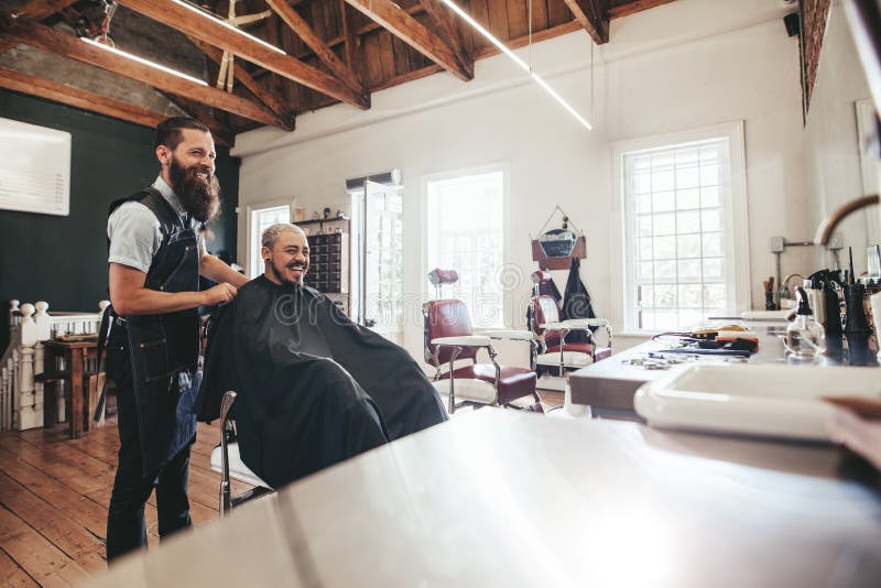 Hairdresser with client sitting at salon and smiling stock image Hairdresser with client sitting at salon and smiling stock image