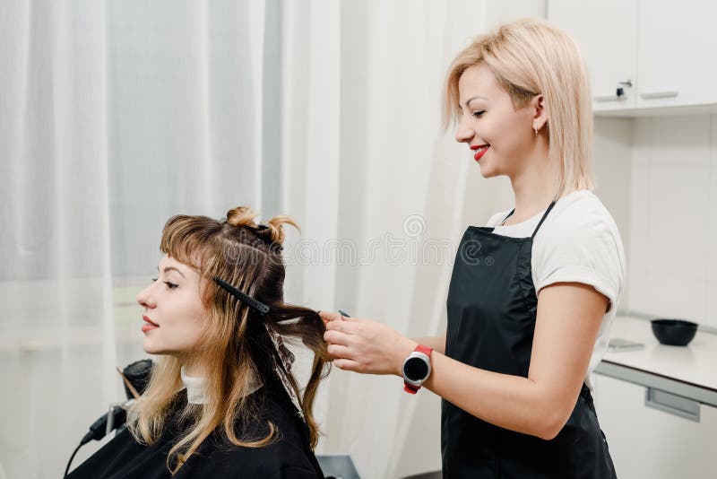 Hairdresser dyeing hair