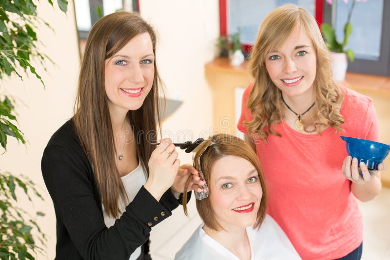 Hairdresser dying hair of client