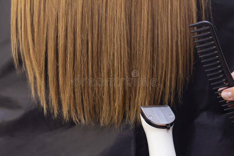 Hairdresser with a Hair Machine. Cutting Off Split Ends of Hair with a Clipper. Close Up Stock Photo - Image of face, blonde: 171910864 Hairdresser with a Hair Machine. Cutting Off Split Ends of Hair with a Clipper. Close Up Stock Photo - Image of face, blonde: 171910864