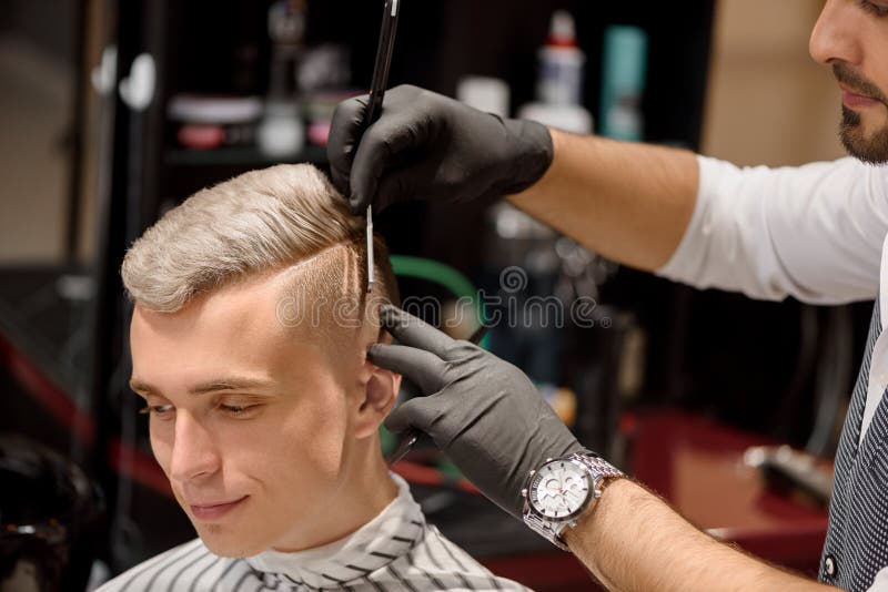 Hairdresser making professional and stylish haircut to client. royalty free stock image Hairdresser making professional and stylish haircut to client. royalty free stock image