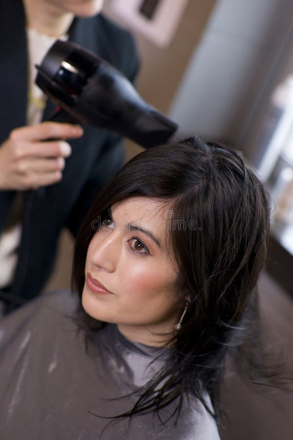 Woman Receives Hairdry at Professional Salon