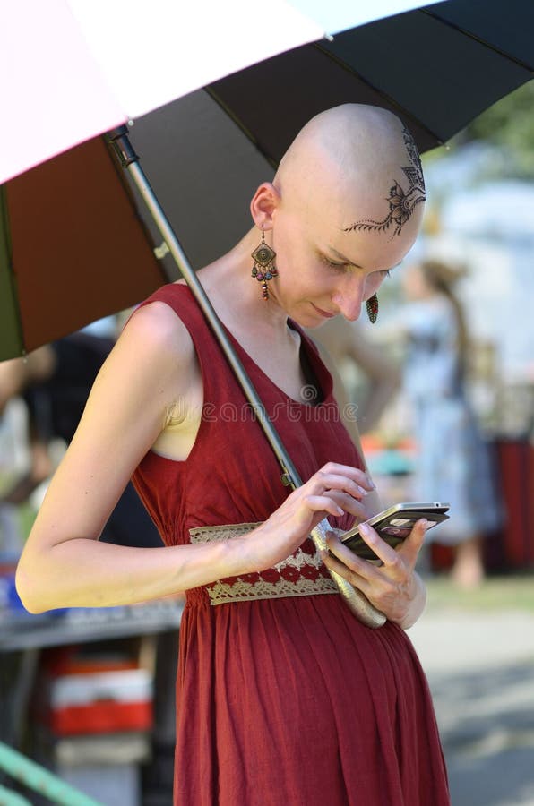 Hairless Krishna Girl Holding Umbrella Looking in the Mobile Phone Editorial Photography - Image of looking, woman: 217189782 Hairless Krishna Girl Holding Umbrella Looking in the Mobile Phone Editorial Photography - Image of looking, woman: 217189782