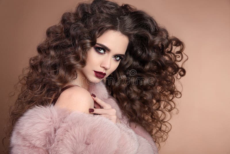 Hairstyle. Beauty hair. Fashion brunette girl with long curly ha