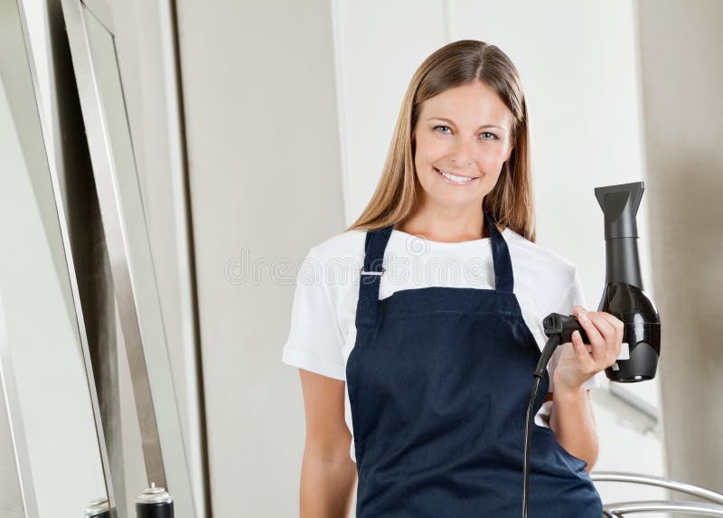 Hairstylist With Hair Dryer In Parlor