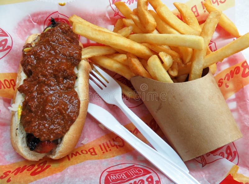 Photo of half smoke with chili and french fries at ben`s chili bowl restaurant in washington dc on 8/22/18. This is the 60th anniversary of this popular restaurant on u street which serves half smokes, bowls of chili, hot dogs, hamburgers and french fries. This restaurant is best known for its bowls of chili and half smokes covered with onions, mustard and chili. Photo of half smoke with chili and french fries at ben`s chili bowl restaurant in washington dc on 8/22/18. This is the 60th anniversary of this popular restaurant on u street which serves half smokes, bowls of chili, hot dogs, hamburgers and french fries. This restaurant is best known for its bowls of chili and half smokes covered with onions, mustard and chili.
